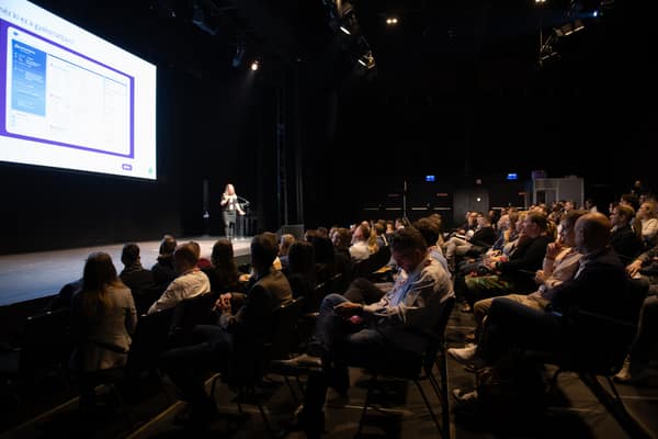 Speaker on stage in front of a full auditorium
